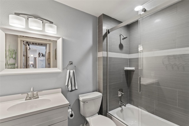 full bathroom featuring bath / shower combo with glass door, vanity, and toilet