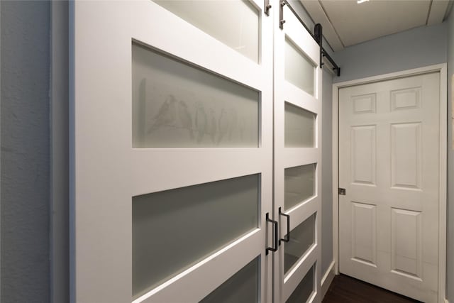 interior space featuring a barn door and hardwood / wood-style floors