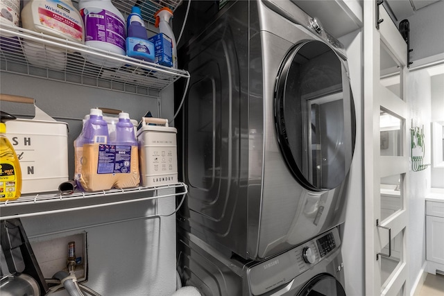 washroom featuring stacked washer and clothes dryer