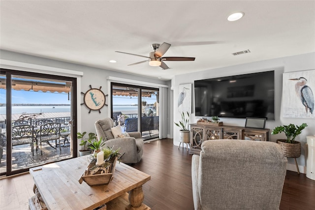 living room featuring dark hardwood / wood-style flooring and ceiling fan