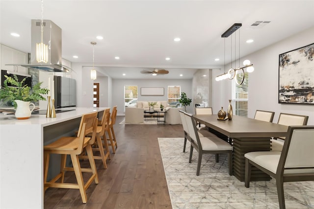 dining space featuring wood-type flooring