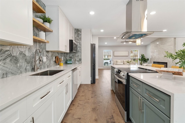 kitchen featuring stainless steel appliances, white cabinetry, sink, and island exhaust hood