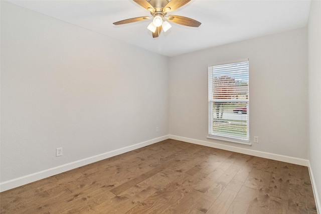 spare room with ceiling fan and wood-type flooring