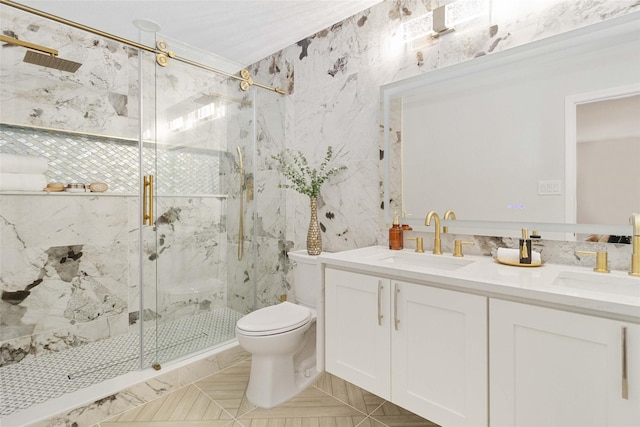 bathroom featuring a shower with door, tile patterned floors, vanity, and toilet