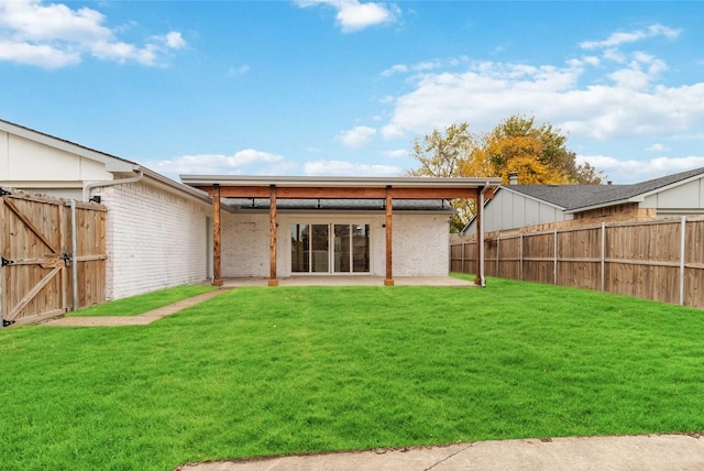 rear view of house with a patio area and a lawn