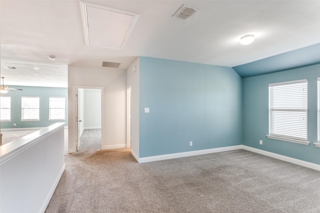 carpeted empty room with vaulted ceiling and ceiling fan