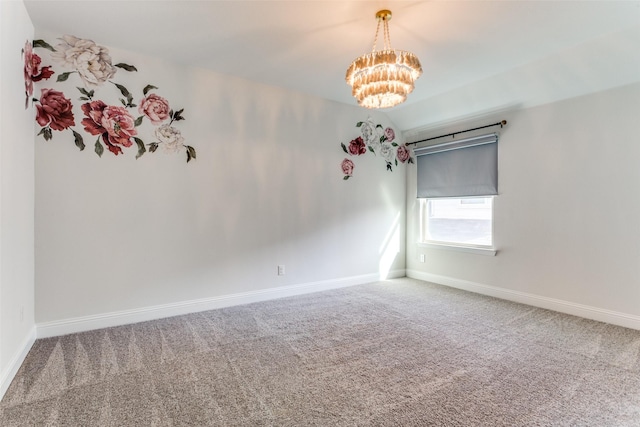 carpeted spare room with a notable chandelier