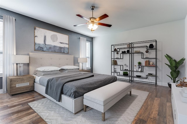 bedroom with dark hardwood / wood-style flooring and ceiling fan