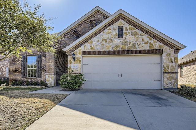 view of front facade with a garage, stone siding, and driveway