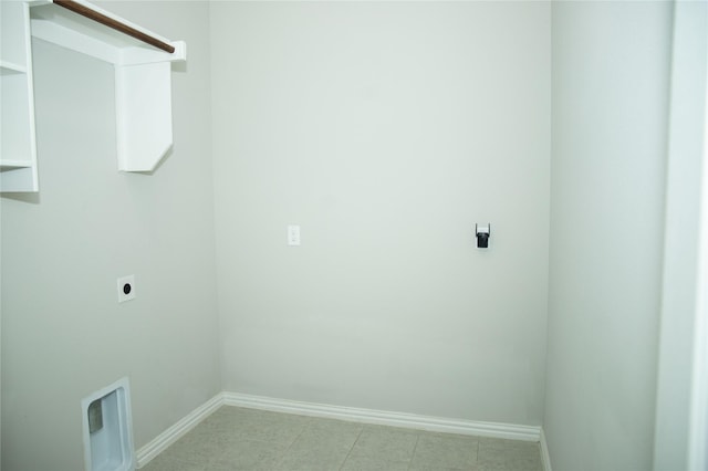 laundry room featuring electric dryer hookup and light tile patterned floors