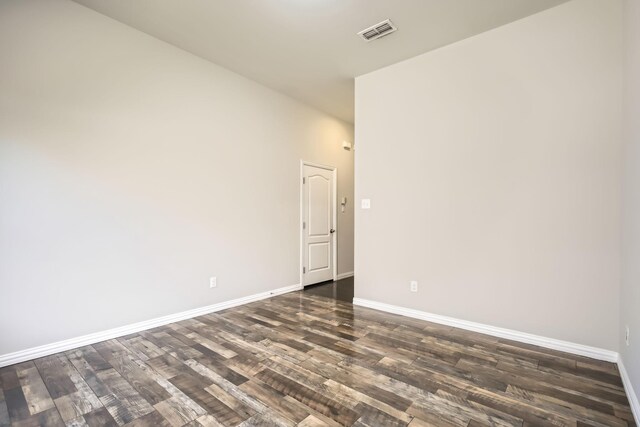 spare room featuring dark wood-type flooring