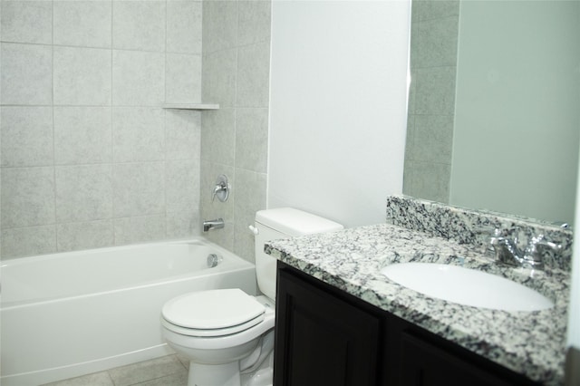 full bathroom featuring tile patterned flooring, vanity, tiled shower / bath combo, and toilet