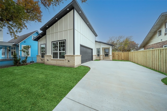 view of home's exterior with a lawn and a garage