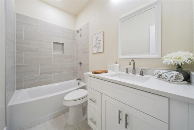 full bathroom featuring vanity, toilet, and tiled shower / bath