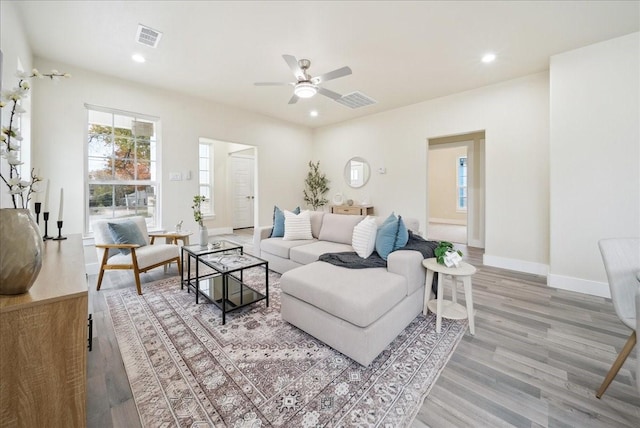 living room featuring ceiling fan and light hardwood / wood-style floors