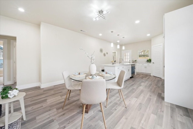 dining area featuring light hardwood / wood-style flooring and sink