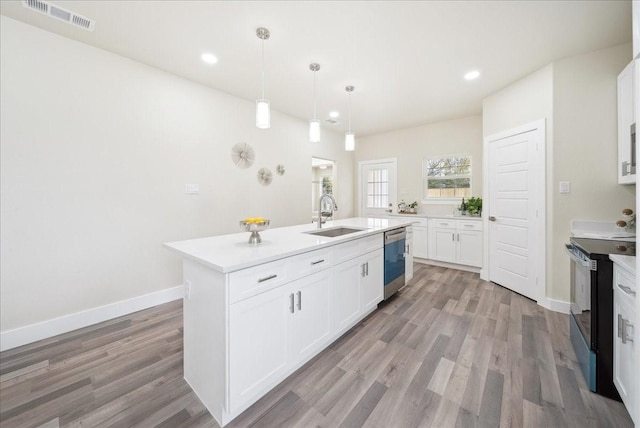 kitchen with a center island with sink, light hardwood / wood-style flooring, stainless steel dishwasher, black electric range, and white cabinetry