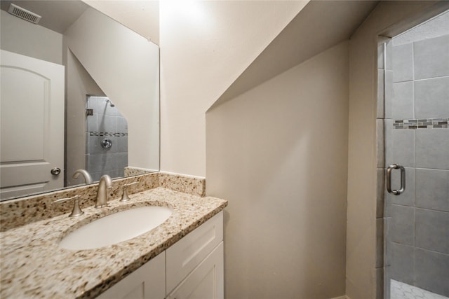 bathroom featuring vanity and an enclosed shower