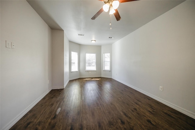 spare room with ceiling fan and dark hardwood / wood-style flooring