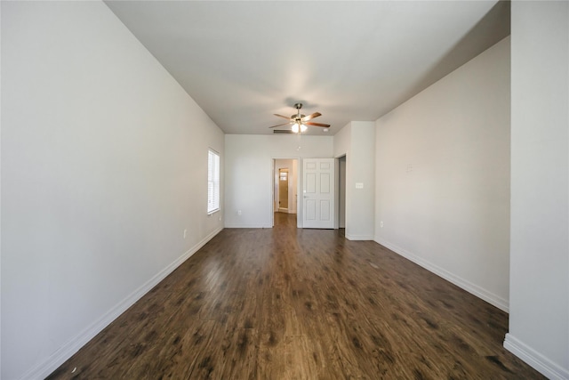 spare room featuring ceiling fan and dark wood-type flooring