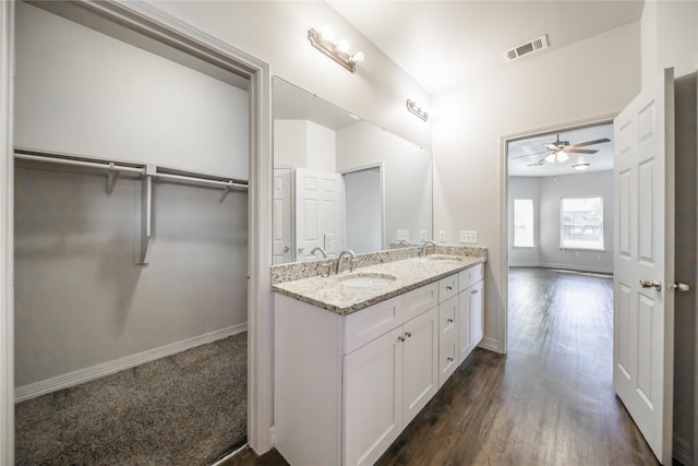 bathroom with wood-type flooring, vanity, and ceiling fan