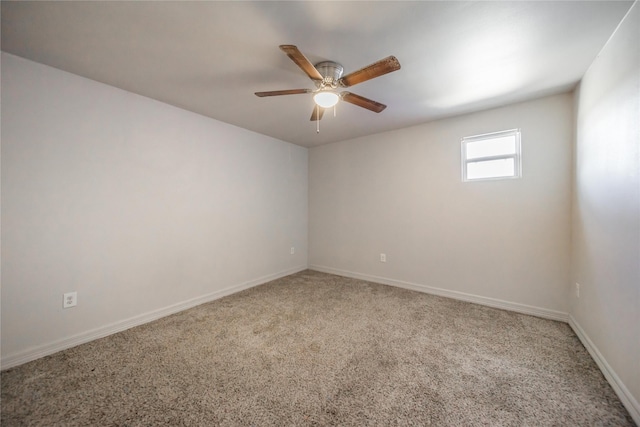 empty room featuring ceiling fan and carpet