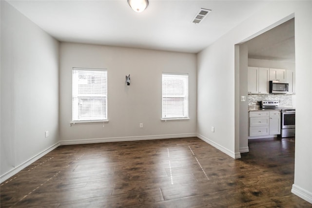 empty room featuring dark wood-type flooring