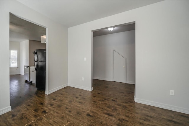 empty room with dark hardwood / wood-style floors