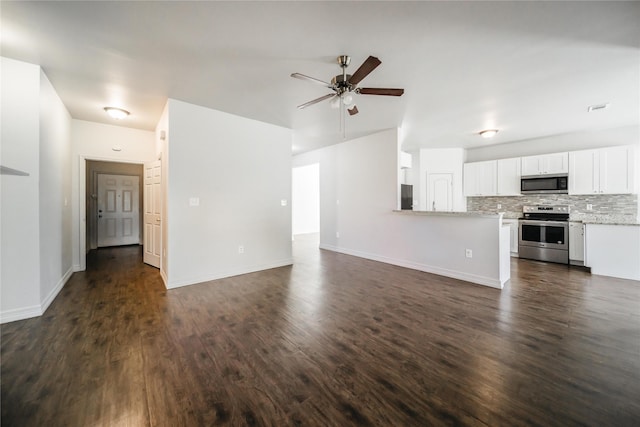 unfurnished living room featuring dark hardwood / wood-style flooring and ceiling fan