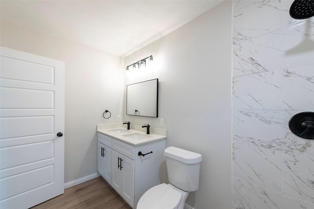 bathroom featuring hardwood / wood-style flooring, vanity, and toilet