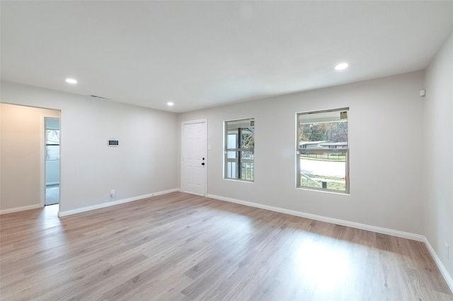 spare room featuring light hardwood / wood-style flooring