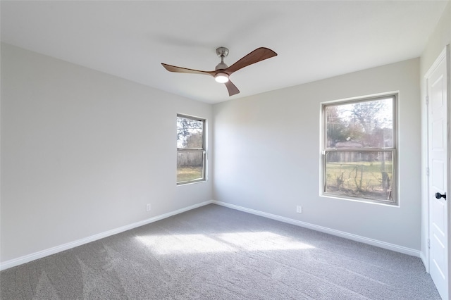 spare room with ceiling fan, carpet, and a healthy amount of sunlight