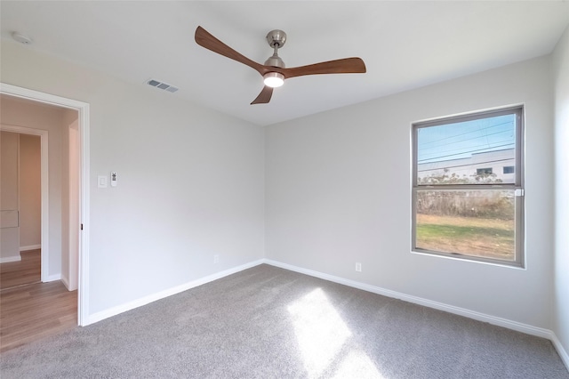 spare room featuring ceiling fan and carpet floors