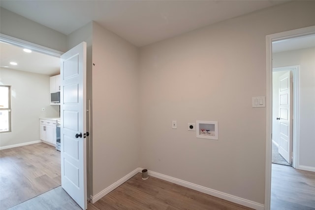 laundry room featuring washer hookup, electric dryer hookup, and light hardwood / wood-style floors