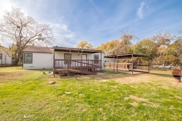 back of property with a lawn and a wooden deck