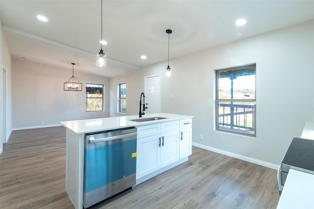 kitchen with stainless steel dishwasher, decorative light fixtures, white cabinetry, and a wealth of natural light