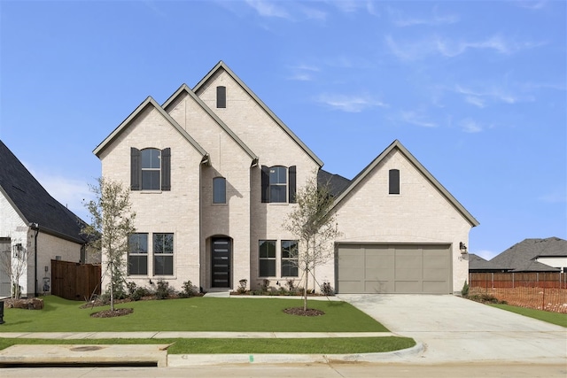 french provincial home with a front yard and a garage