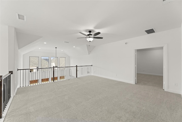 interior space with ceiling fan, lofted ceiling, and light carpet