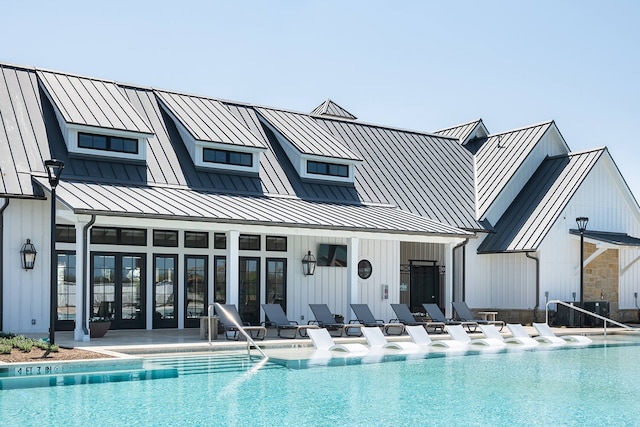 rear view of house with a patio area and a community pool