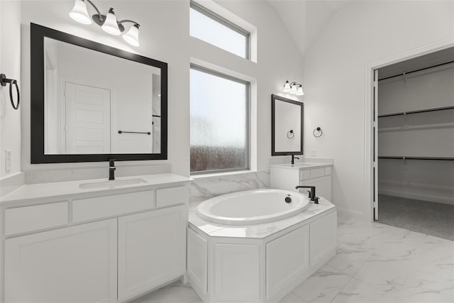 bathroom featuring vanity, a bathtub, and lofted ceiling