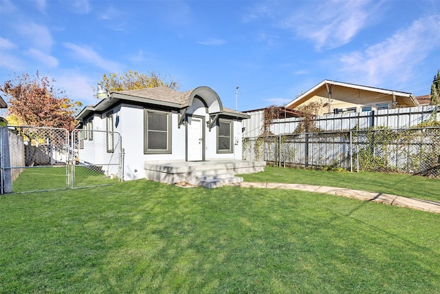 rear view of property featuring a yard