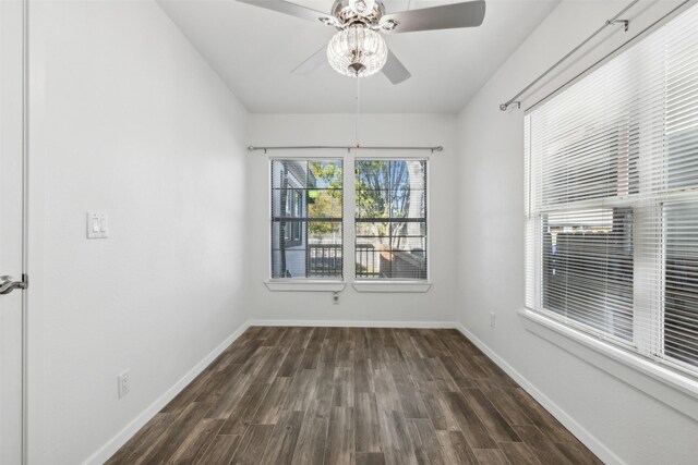 unfurnished room with dark wood-type flooring and ceiling fan