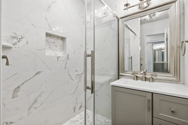 bathroom featuring vanity and a shower with door