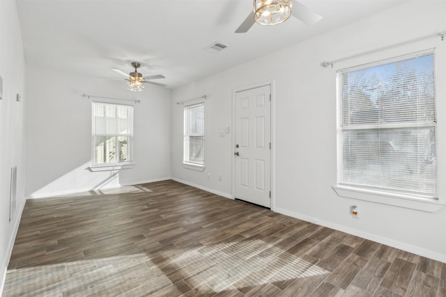 entrance foyer featuring ceiling fan, dark wood-type flooring, and a wealth of natural light