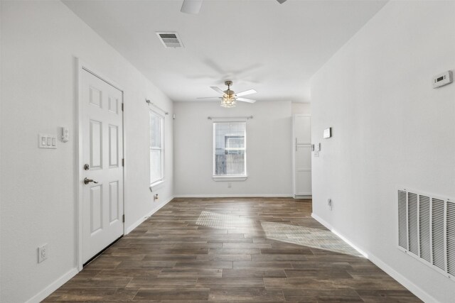 spare room featuring dark hardwood / wood-style floors and ceiling fan