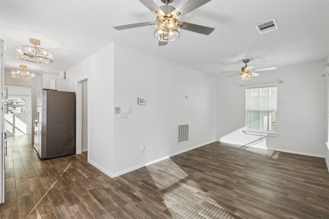 unfurnished living room with a chandelier and dark hardwood / wood-style flooring