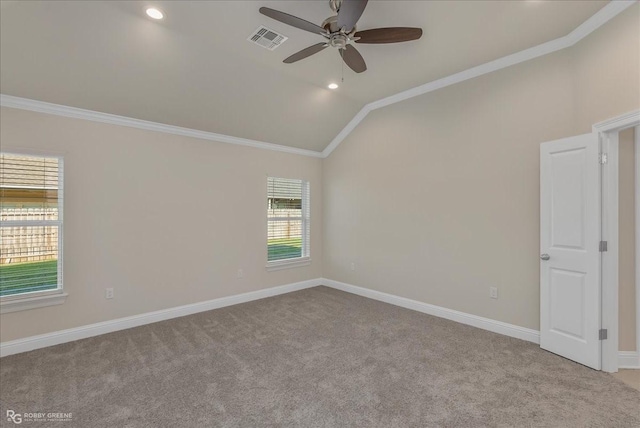 carpeted spare room featuring ceiling fan, lofted ceiling, and ornamental molding