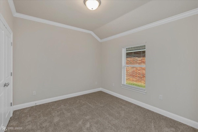 carpeted spare room featuring crown molding and lofted ceiling