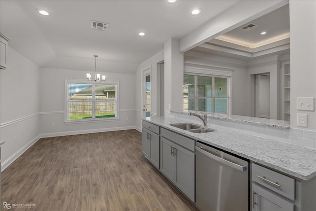 kitchen featuring stainless steel dishwasher, light stone countertops, and hardwood / wood-style floors