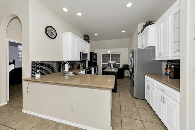 kitchen featuring white cabinets, sink, hanging light fixtures, and appliances with stainless steel finishes